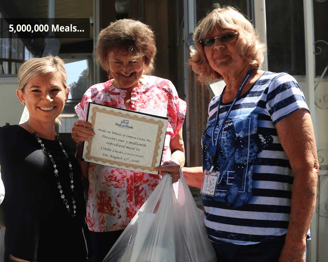 A woman receives a certificate for the 5 millionth meal served by Meals on Wheels Contra Costa