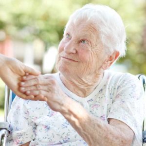 an elderly woman receiving a helping hand