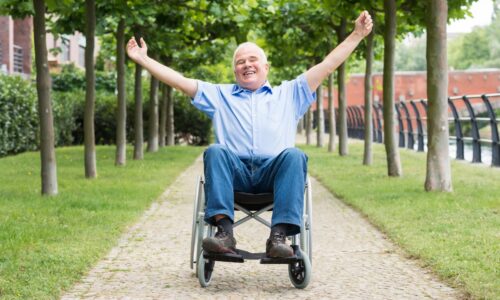 a smiling senior in a wheelchair